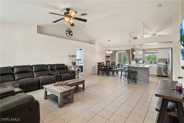 927 NW 12th Ter, Cape Coral, FL 33993 - living area featuring light tile patterned flooring, ceiling fan, and vaulted ceiling