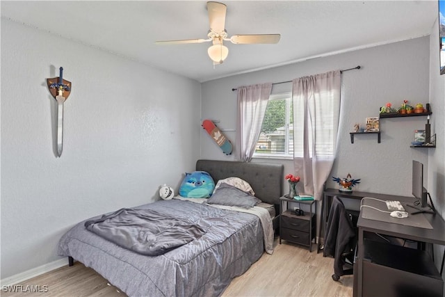 927 NW 12th Ter, Cape Coral, FL 33993 - bedroom with wood finished floors, an office area, a ceiling fan, and baseboards