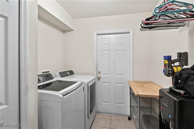 927 NW 12th Ter, Cape Coral, FL 33993 - laundry area with washer and dryer and light tile patterned floors