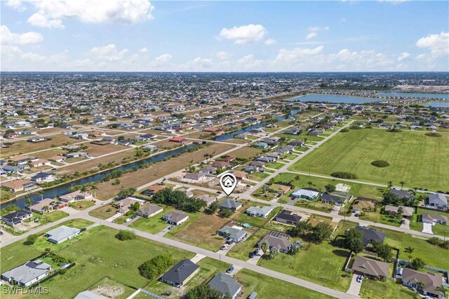 927 NW 12th Ter, Cape Coral, FL 33993 - aerial view of property and surrounding area featuring a nearby body of water and nearby suburban area