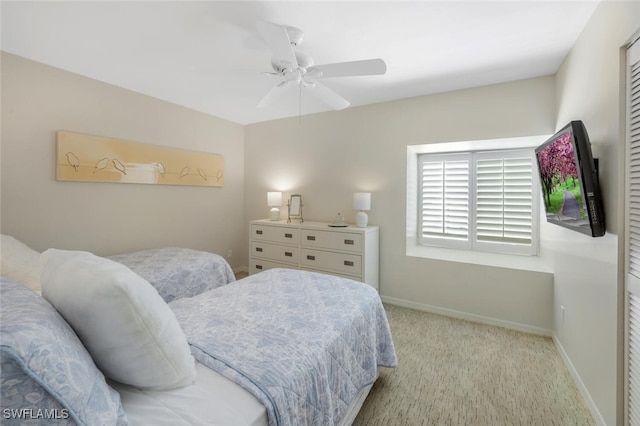 bedroom featuring carpet floors, baseboards, and a ceiling fan