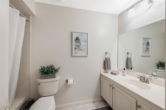 full bath featuring toilet, vanity, tile patterned flooring, and baseboards