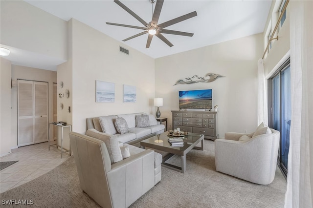 living room featuring ceiling fan and carpet