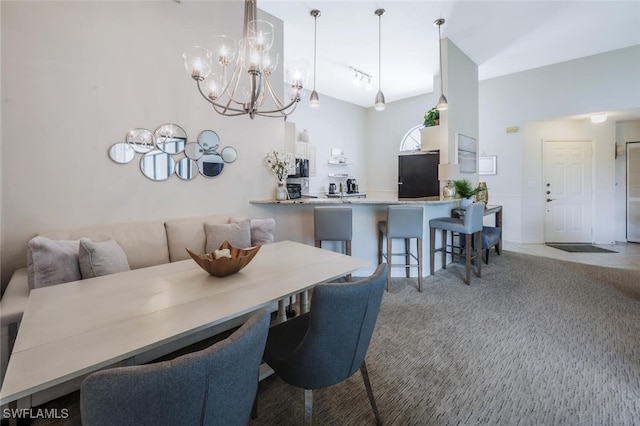 carpeted dining space with a chandelier