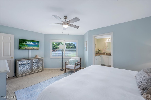 bedroom featuring carpet flooring, ensuite bath, a ceiling fan, and baseboards