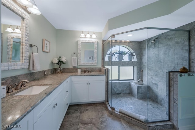bathroom featuring a stall shower and double vanity