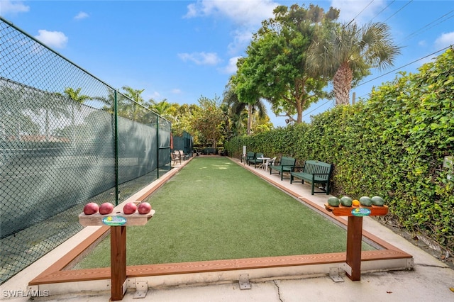 surrounding community featuring a game area and fence