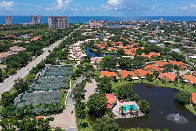 aerial view of property's location with a large body of water and nearby suburban area
