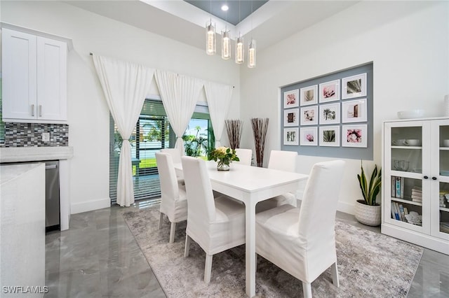 dining space with a chandelier and baseboards
