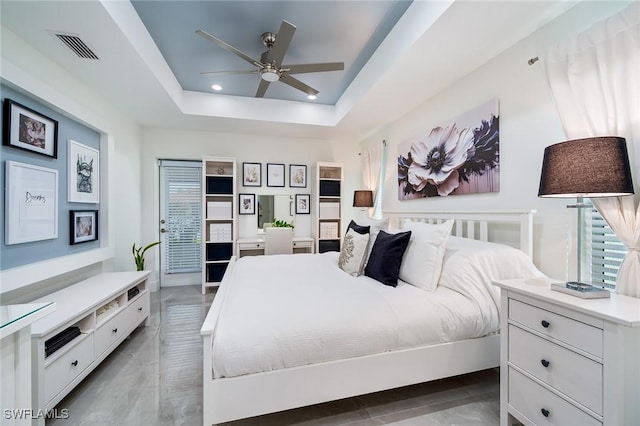 bedroom featuring a tray ceiling, recessed lighting, and a ceiling fan