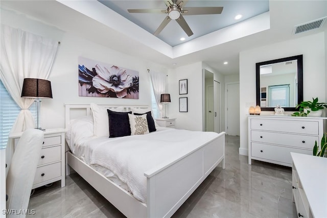 bedroom with recessed lighting, a tray ceiling, and ceiling fan