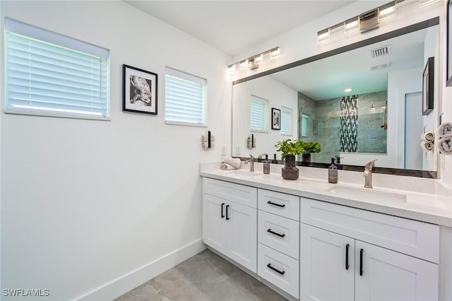 full bathroom with a shower stall and double vanity