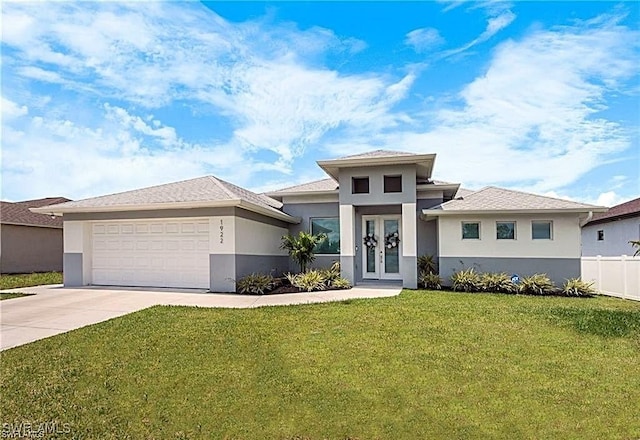 prairie-style home with french doors, stucco siding, concrete driveway, and a garage