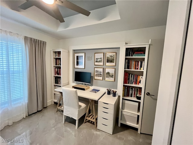 home office featuring a ceiling fan and concrete flooring
