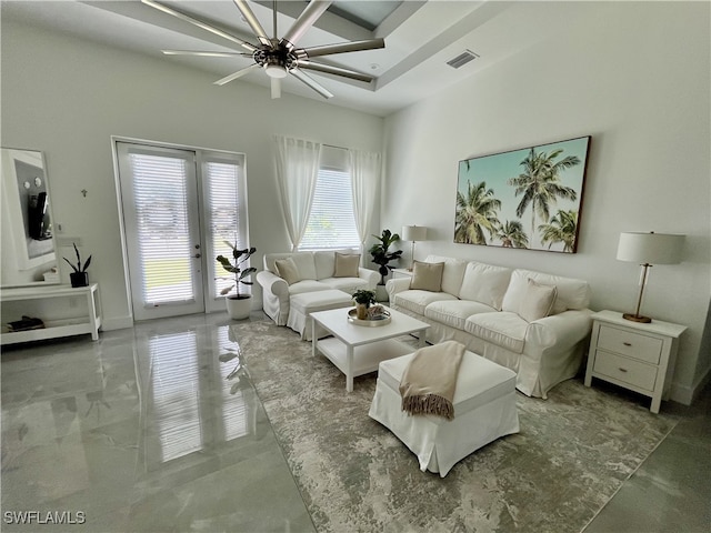 living room with a ceiling fan, french doors, and a high ceiling