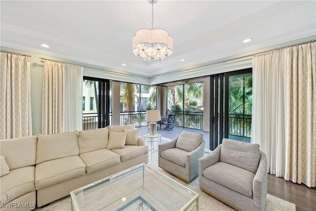 2745 Tiburon Blvd E Unit 102, Naples, FL 34109 - living area featuring a chandelier, recessed lighting, wood finished floors, and crown molding