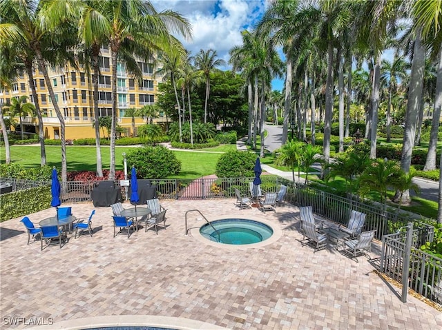 2745 Tiburon Blvd E Unit 102, Naples, FL 34109 - view of pool featuring a community hot tub and a patio area