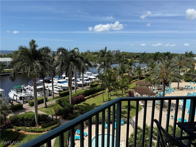 balcony featuring a water view and view of pool