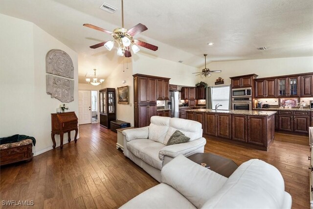 6721 Southwell Dr, Fort Myers, FL 33966 - living area with lofted ceiling, ceiling fan, dark wood-type flooring, and a chandelier