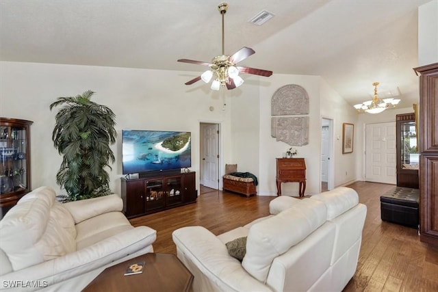 6721 Southwell Dr, Fort Myers, FL 33966 - living area featuring wood finished floors, a chandelier, vaulted ceiling, and a ceiling fan