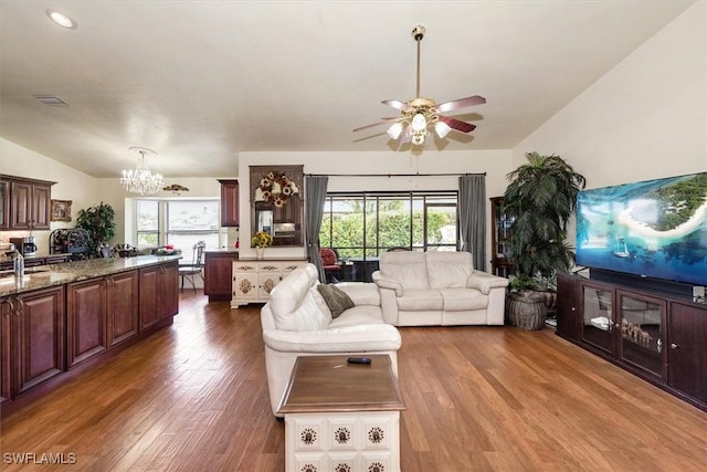 6721 Southwell Dr, Fort Myers, FL 33966 - living area featuring a chandelier, wood finished floors, lofted ceiling, ceiling fan, and plenty of natural light