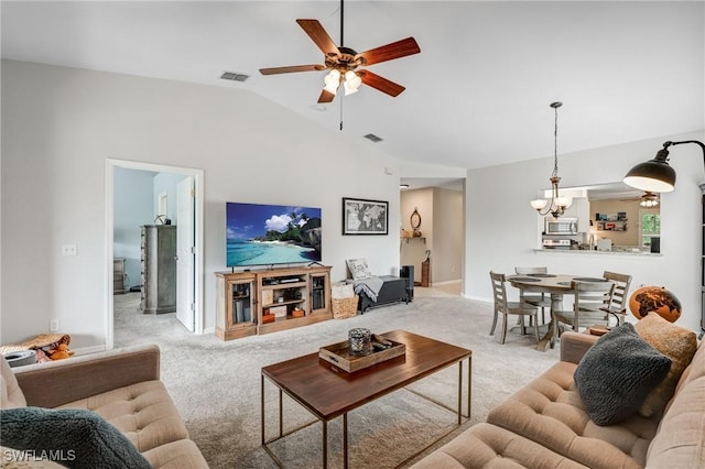 14560 Daffodil Dr Unit 905, Fort Myers, FL 33919 - living room featuring a ceiling fan, light carpet, vaulted ceiling, a chandelier, and baseboards