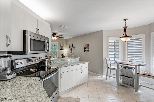 14560 Daffodil Dr Unit 905, Fort Myers, FL 33919 - kitchen featuring appliances with stainless steel finishes, a peninsula, a ceiling fan, decorative light fixtures, and white cabinets