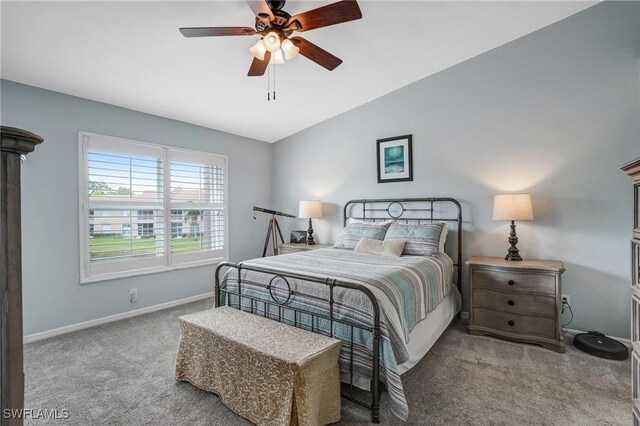 bedroom with carpet flooring, baseboards, ceiling fan, and lofted ceiling