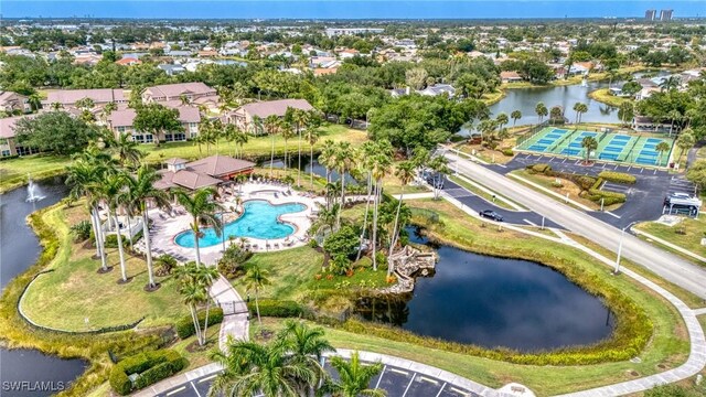 aerial view of property's location featuring a nearby body of water and a pool area