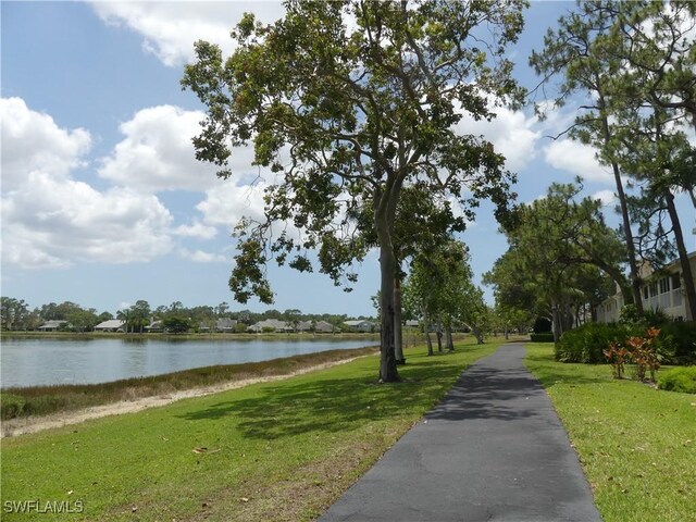 1704 Kings Lake Blvd Unit 105, Naples, FL 34112 - view of home's community with a water view and a lawn
