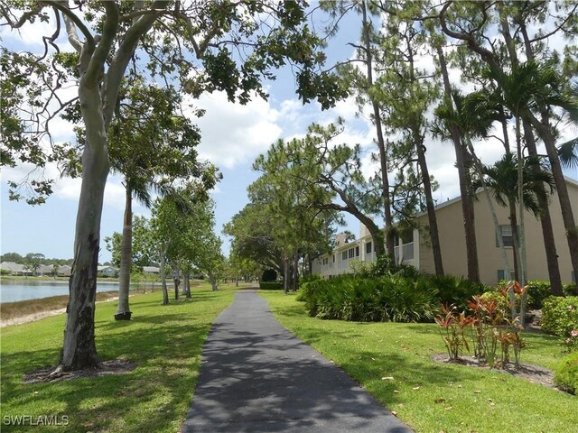 1704 Kings Lake Blvd Unit 105, Naples, FL 34112 - surrounding community with a yard and a water view