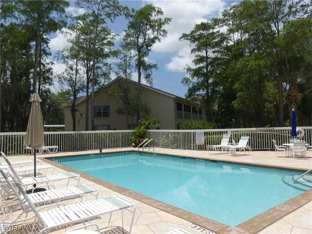 1704 Kings Lake Blvd Unit 105, Naples, FL 34112 - community pool featuring a patio area