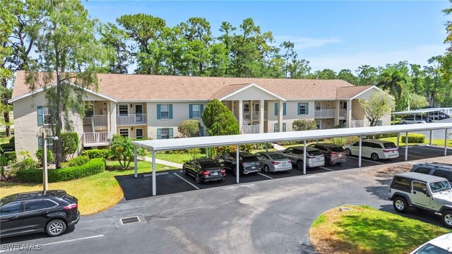 1704 Kings Lake Blvd Unit 105, Naples, FL 34112 - covered parking lot with a residential view
