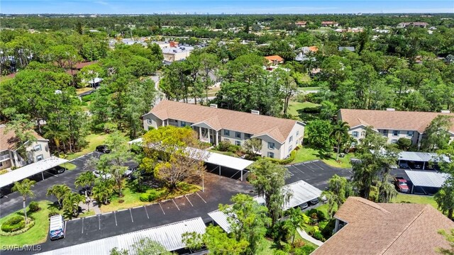 1704 Kings Lake Blvd Unit 105, Naples, FL 34112 - aerial perspective of suburban area with a tree filled landscape