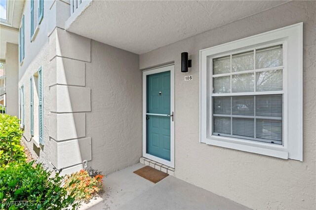 1704 Kings Lake Blvd Unit 105, Naples, FL 34112 - entrance to property with stucco siding