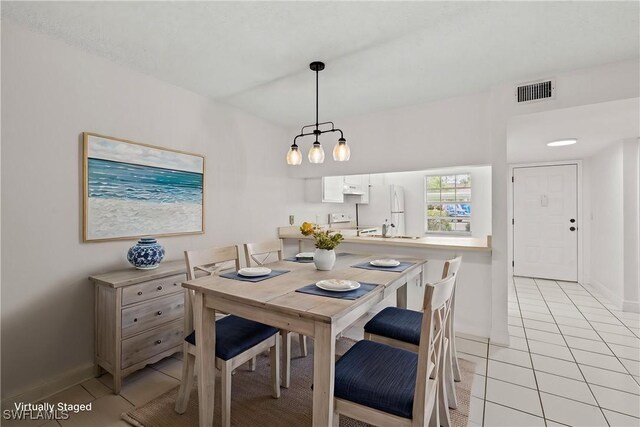1704 Kings Lake Blvd Unit 105, Naples, FL 34112 - dining area featuring light tile patterned floors and baseboards