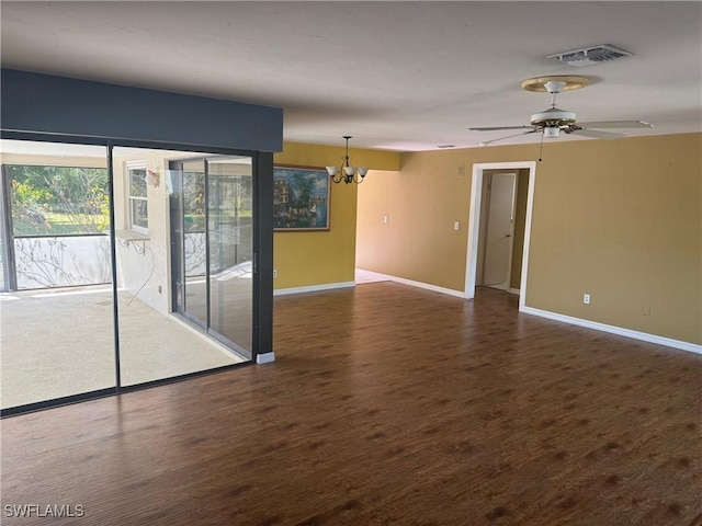 spare room with a chandelier, baseboards, wood finished floors, and ceiling fan