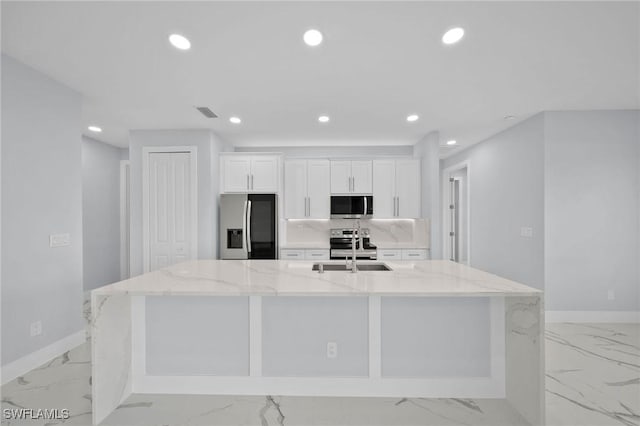 3800 11th St SW, Lee, FL 33976 - kitchen with stainless steel appliances, light marble finish floors, recessed lighting, a large island, and white cabinets