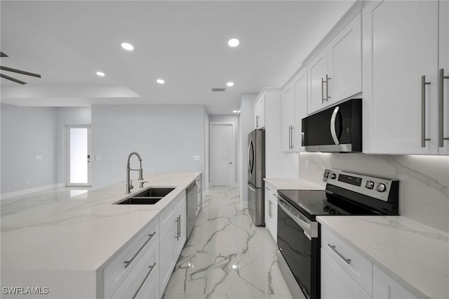 3800 11th St SW, Lee, FL 33976 - kitchen featuring appliances with stainless steel finishes, a sink, recessed lighting, white cabinets, and a large island