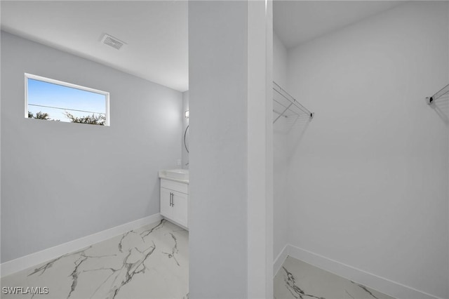 3800 11th St SW, Lee, FL 33976 - bathroom with marble look tile flooring, baseboards, vanity, and a spacious closet