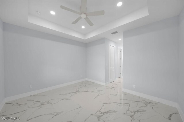 3800 11th St SW, Lee, FL 33976 - empty room with a tray ceiling, recessed lighting, baseboards, marble finish floors, and a ceiling fan