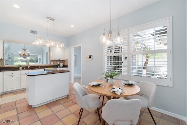 10334 Quail Crown Dr, Naples, FL 34119 - dining space featuring baseboards, light tile patterned floors, recessed lighting, and a chandelier