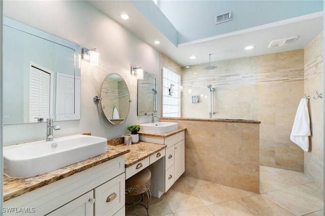10334 Quail Crown Dr, Naples, FL 34119 - full bath featuring walk in shower, two vanities, tile patterned flooring, and recessed lighting