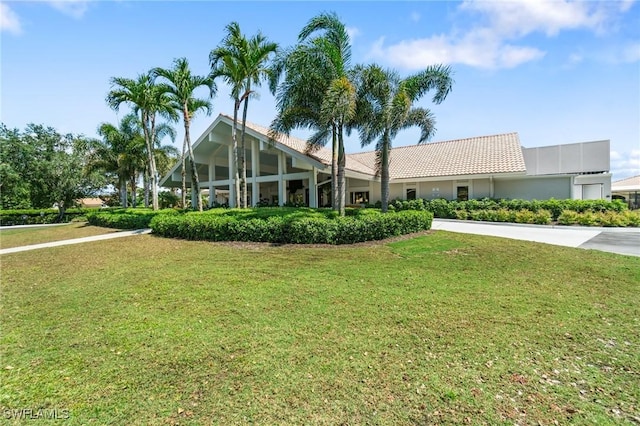 10334 Quail Crown Dr, Naples, FL 34119 - view of front of property with a front lawn, a tiled roof, and stucco siding