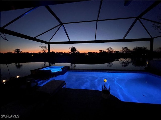 10334 Quail Crown Dr, Naples, FL 34119 - pool at dusk with a patio area, a lanai, and a pool with connected hot tub