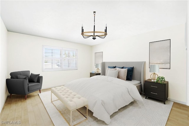 10334 Quail Crown Dr, Naples, FL 34119 - bedroom featuring a chandelier and light wood-type flooring