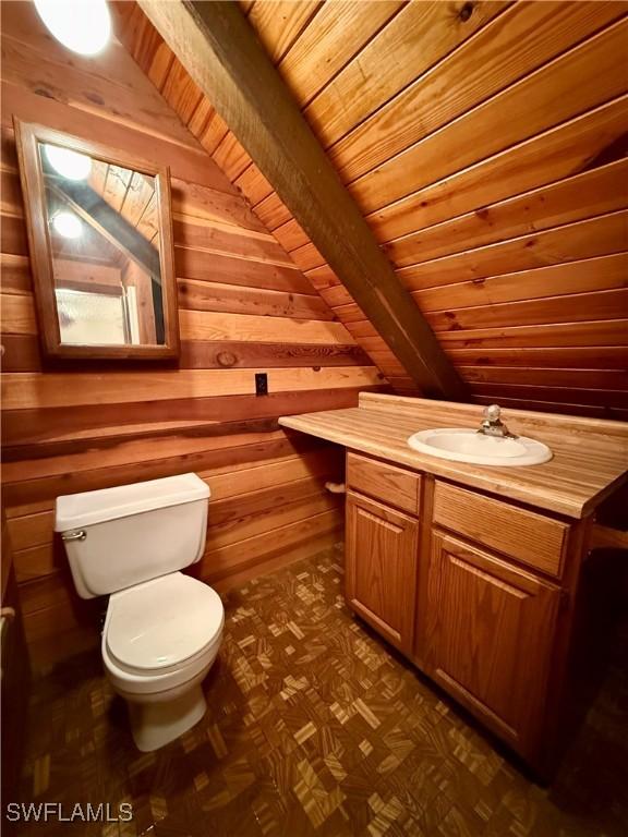 304 Flagler St, Clewiston, FL 33440 - half bathroom with toilet, wood walls, vanity, and wood ceiling