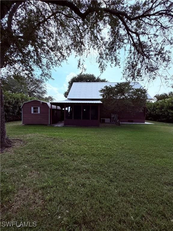 304 Flagler St, Clewiston, FL 33440 - view of green lawn featuring a sunroom