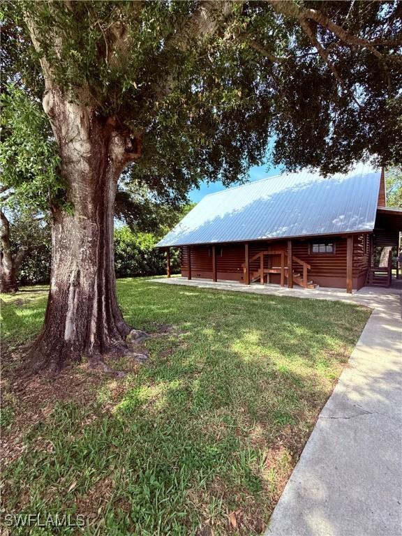 304 Flagler St, Clewiston, FL 33440 - view of front of house with a front lawn and metal roof