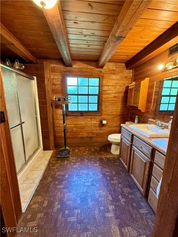 304 Flagler St, Clewiston, FL 33440 - bathroom with wooden ceiling, wood walls, a shower stall, beamed ceiling, and toilet